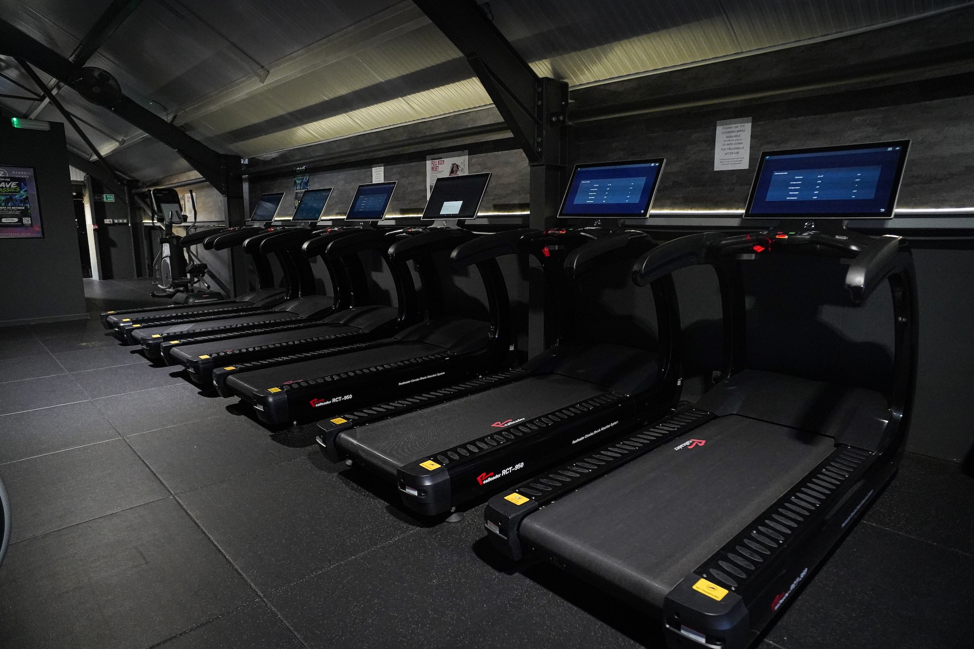 Cardio machines facing the large gable window