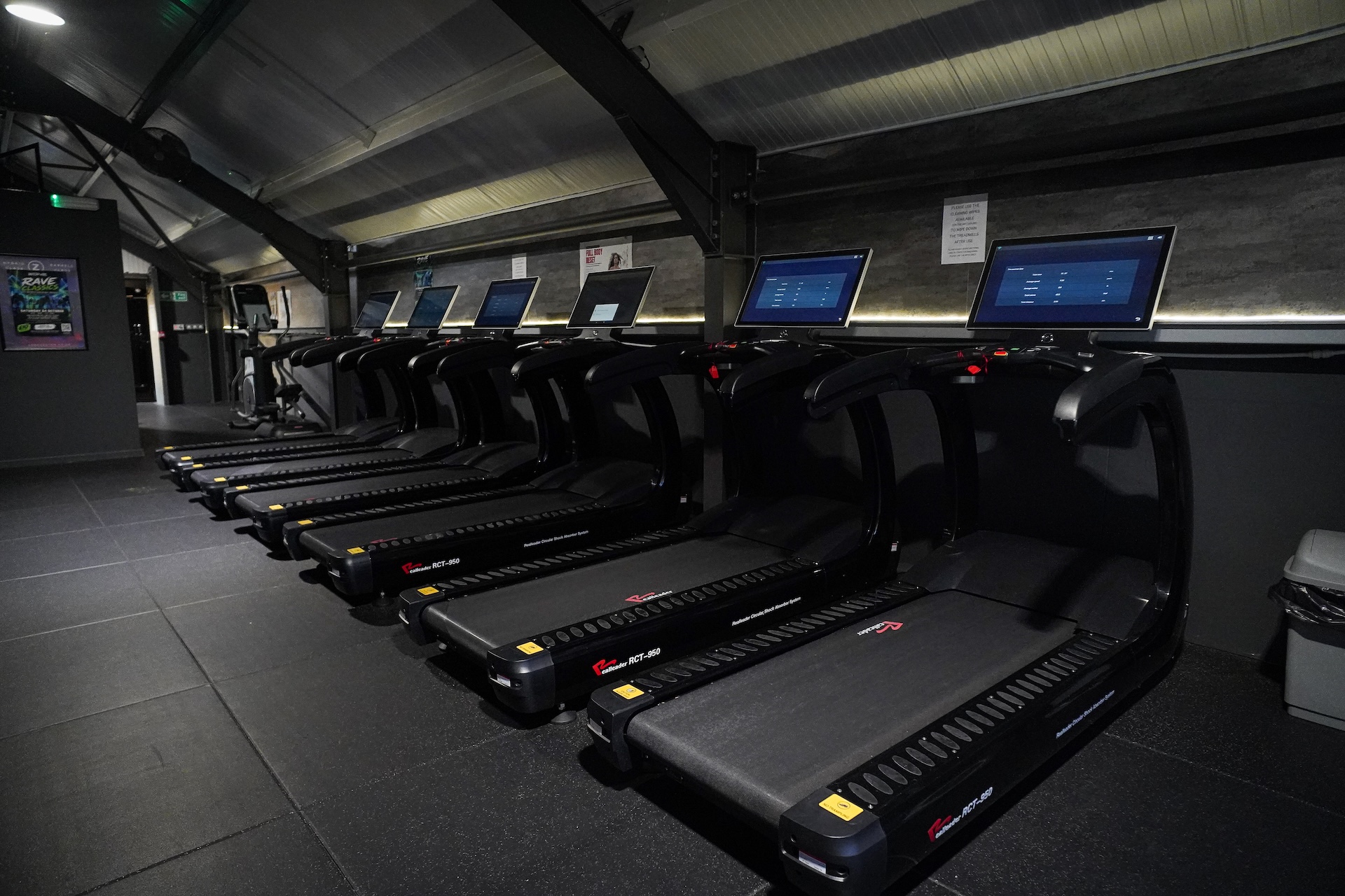 Cardio machines facing the large gable window