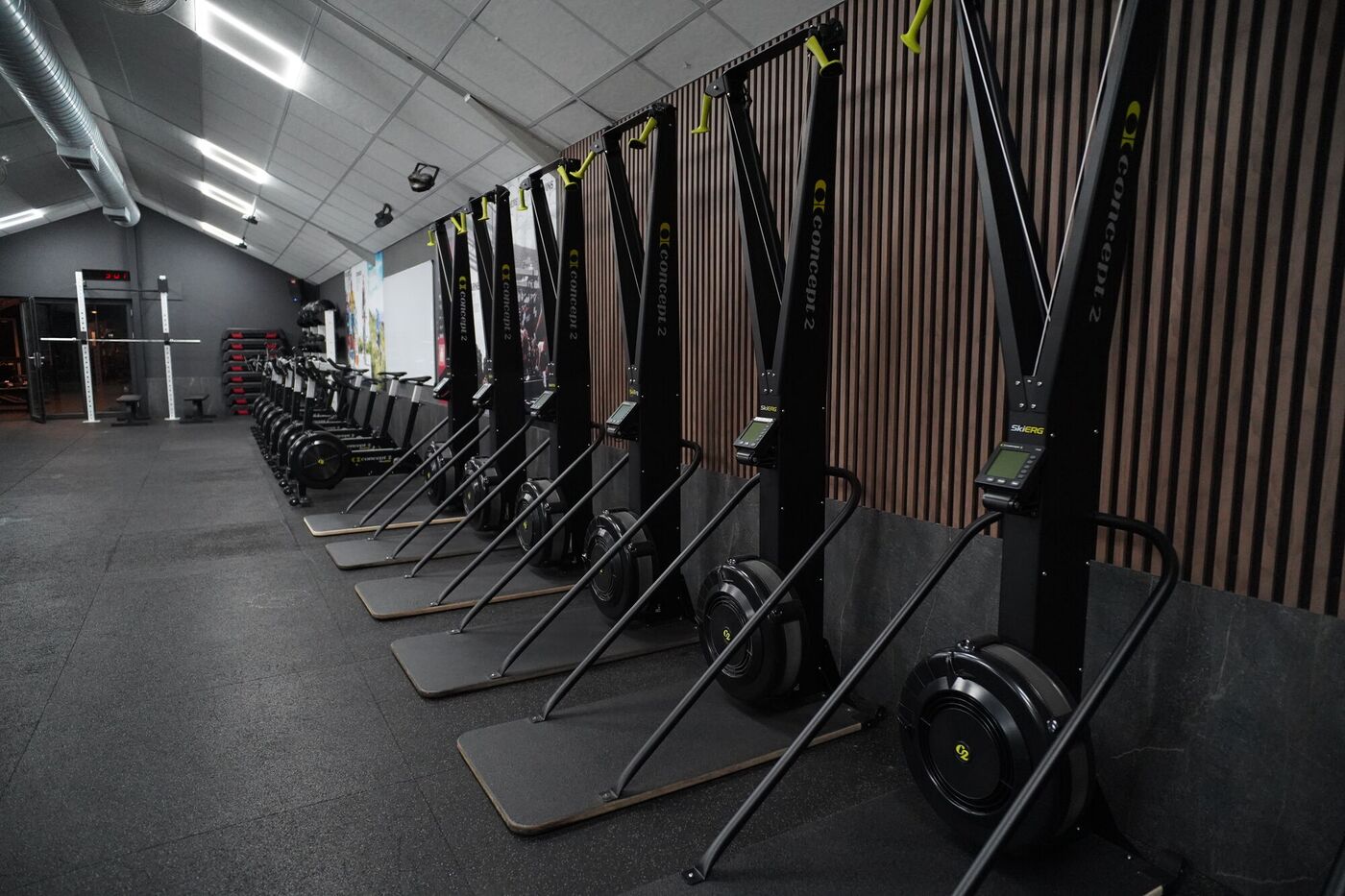 SkiErgs lined up along the slatted wall
