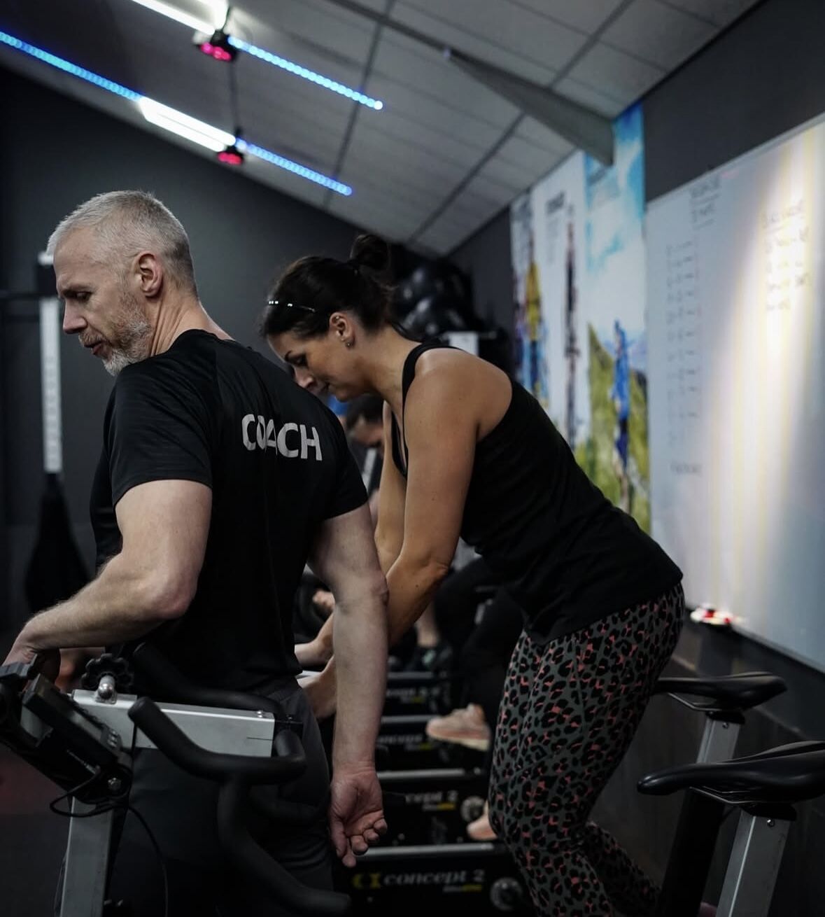 Coach supporting a member on a bike